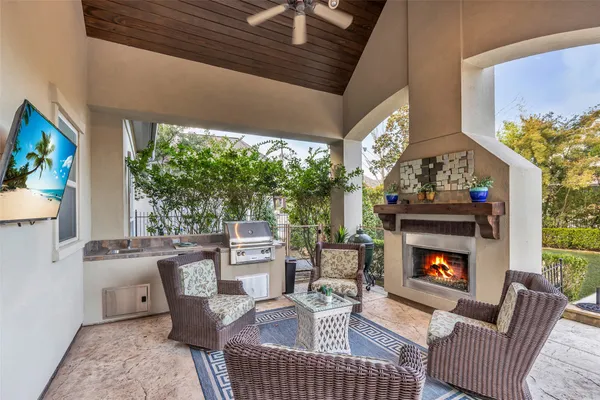 a living room with furniture a fireplace and a floor to ceiling window