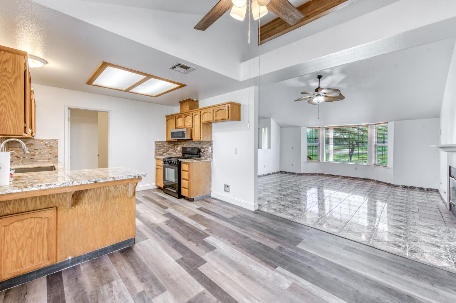 19650 Oakhill Road Madera, CA 93638 - Photo 11 of 49 a view of a kitchen with a sink dishwasher and a refrigerator