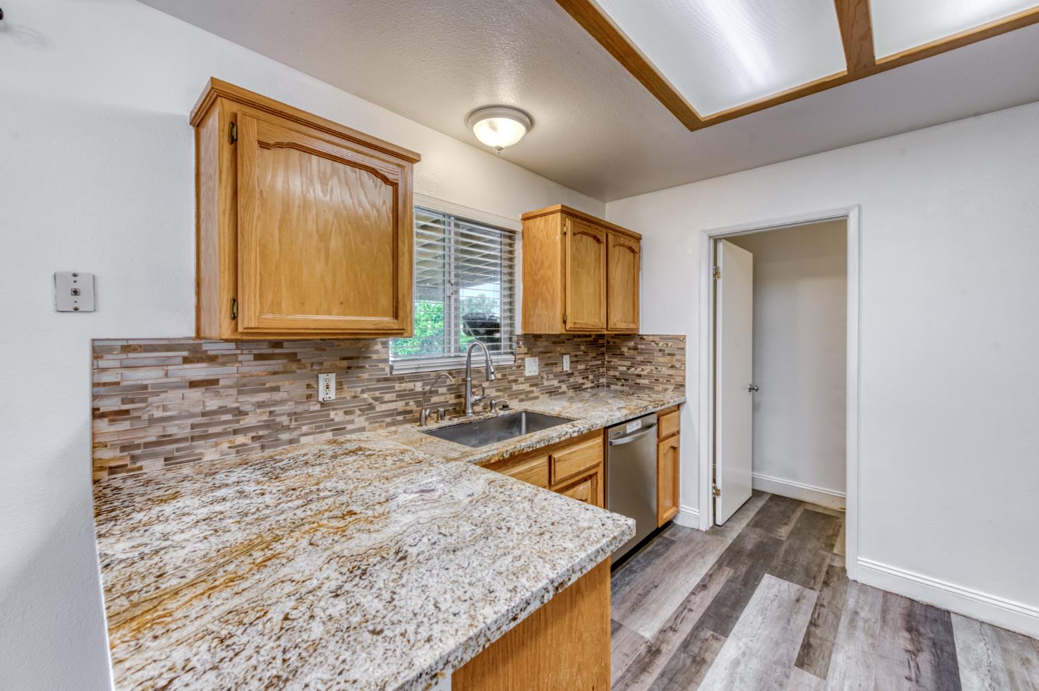 19650 Oakhill Road Madera, CA 93638 - Photo 14 of 49 a bathroom with a granite countertop sink and a mirror