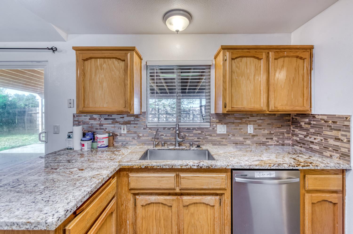 19650 Oakhill Road Madera, CA 93638 - Photo 17 of 49 a kitchen with stainless steel appliances granite countertop a sink stove and cabinets