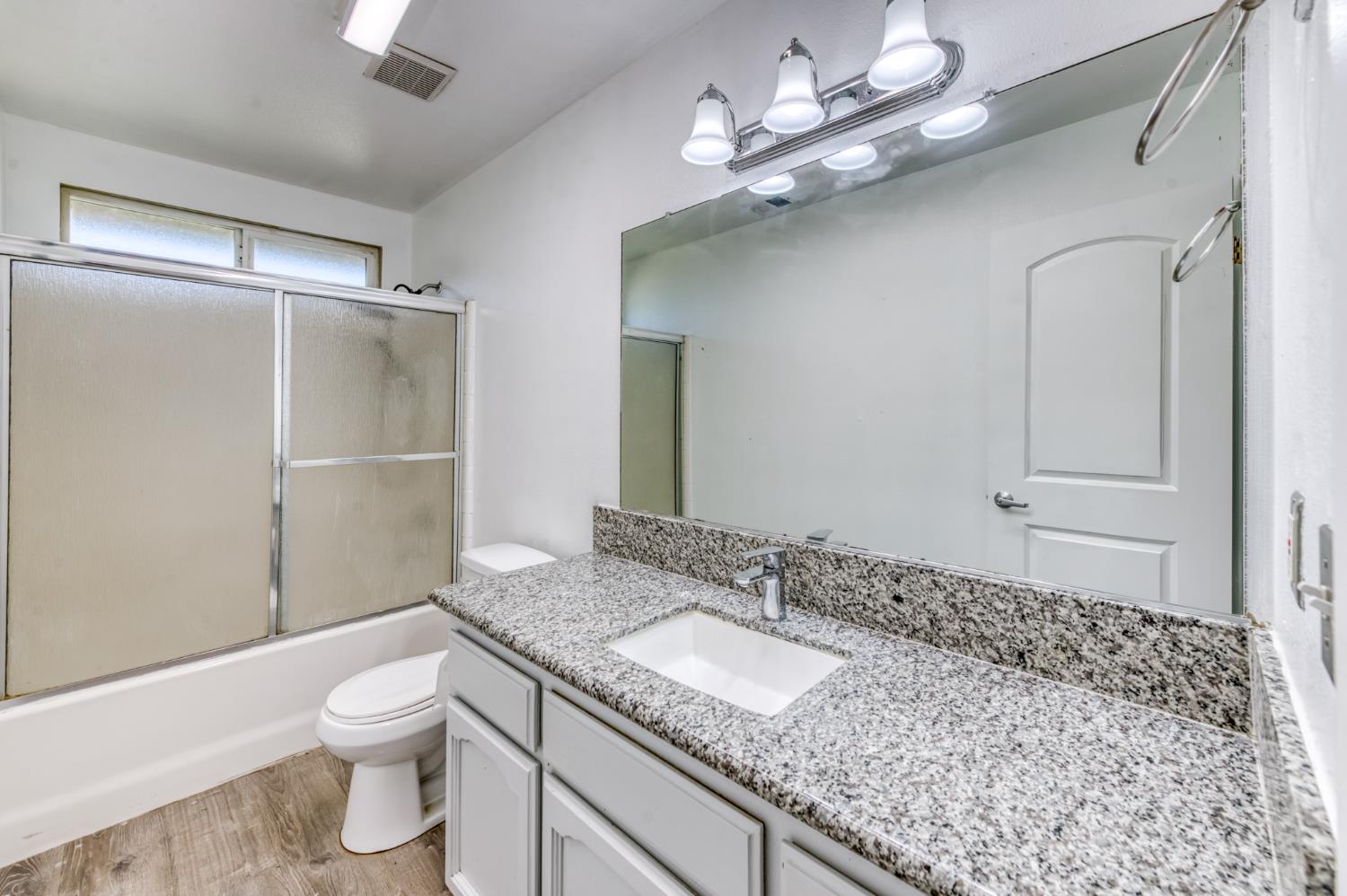 19650 Oakhill Road Madera, CA 93638 - Photo 18 of 49 a bathroom with a granite countertop sink toilet and shower