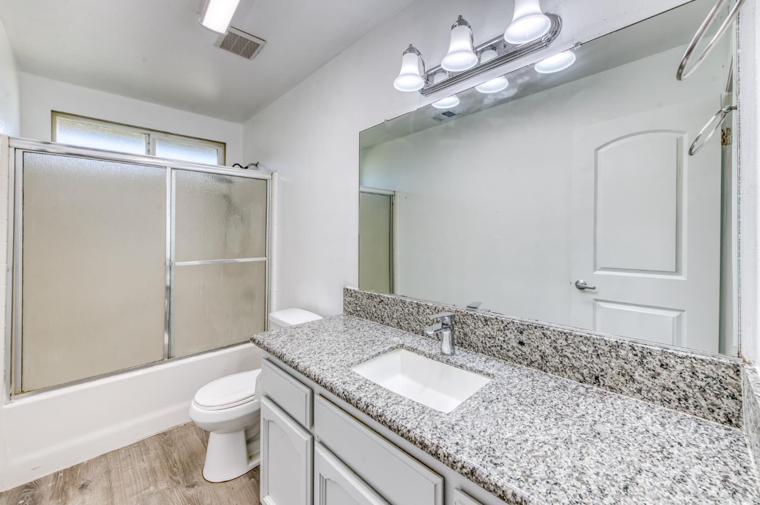 19650 Oakhill Road Madera, CA 93638 - Photo 20 of 49 a bathroom with a granite countertop sink a toilet and shower