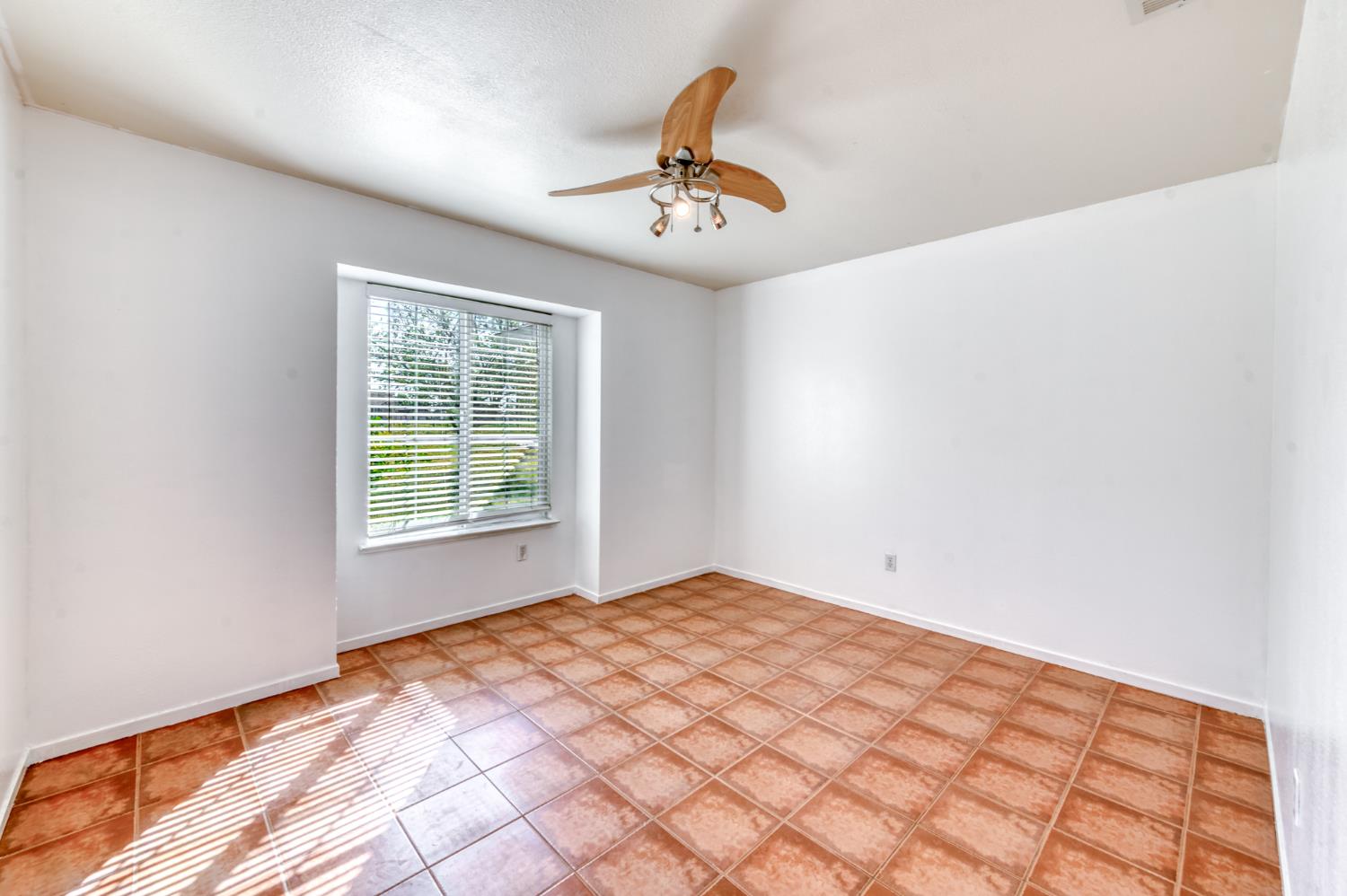 19650 Oakhill Road Madera, CA 93638 - Photo 22 of 49 a bedroom with a bed and a window