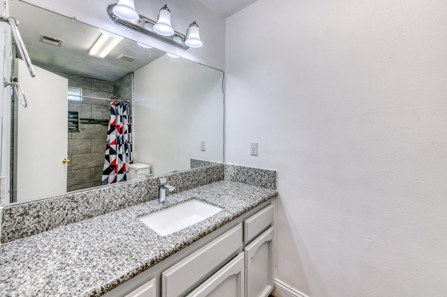 19650 Oakhill Road Madera, CA 93638 - Photo 24 of 49 a bathroom with a granite countertop sink and a mirror