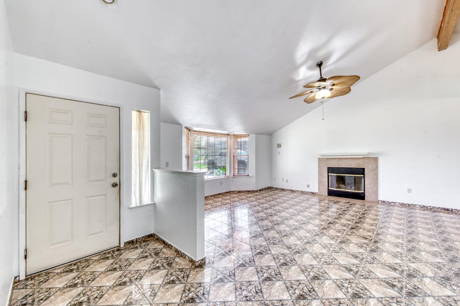 19650 Oakhill Road Madera, CA 93638 - Photo 8 of 49 an empty room with windows and fireplace