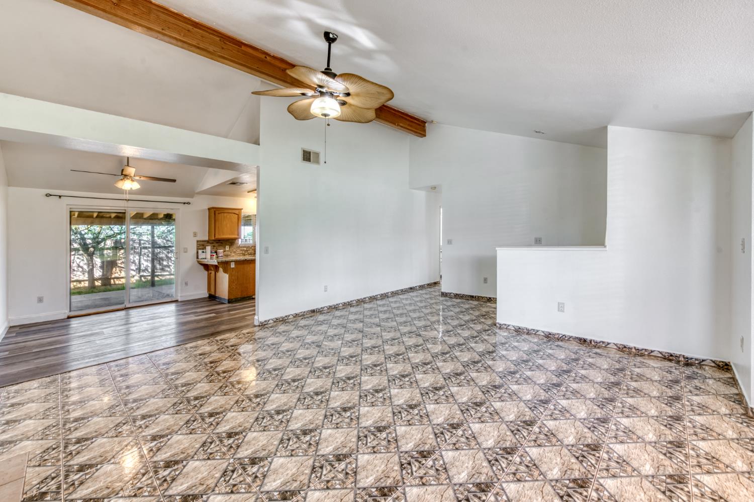 19650 Oakhill Road Madera, CA 93638 - Photo 10 of 49 en empty room with wooden floor and chandelier