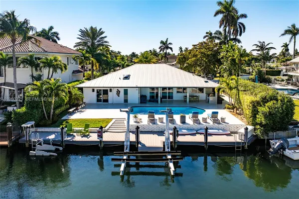 a swimming pool with outdoor seating and yard
