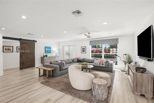 a living room with fireplace furniture and a flat screen tv