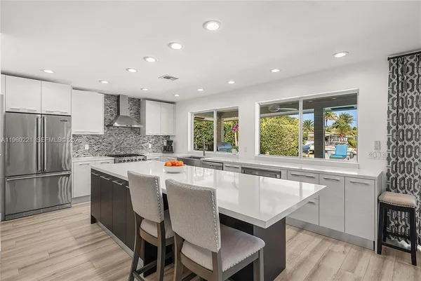 a kitchen with a stove a sink and a refrigerator