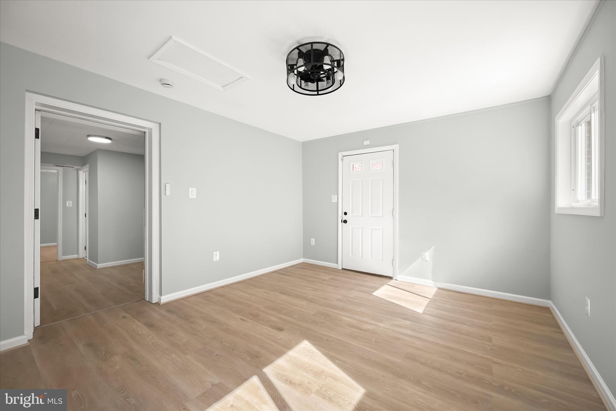 9720 Hedin Drive Silver Spring, MD 20903 - Photo 60 of 79 an empty room with wooden floor and windows