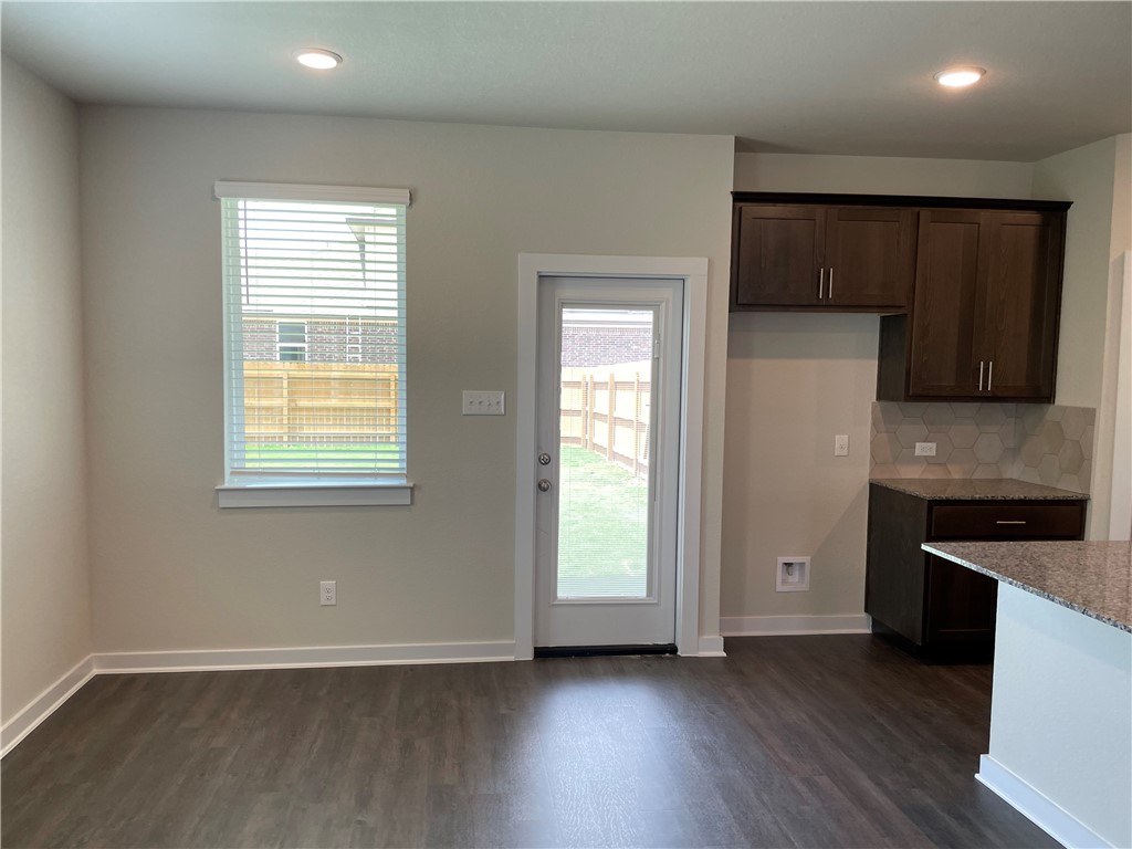 609 Paddock Lane Georgetown, TX 78626 - Photo 18 of 40 Gleaming hardwood floors and recessed lighting enhance this versatile dining area next to the kitchen.
