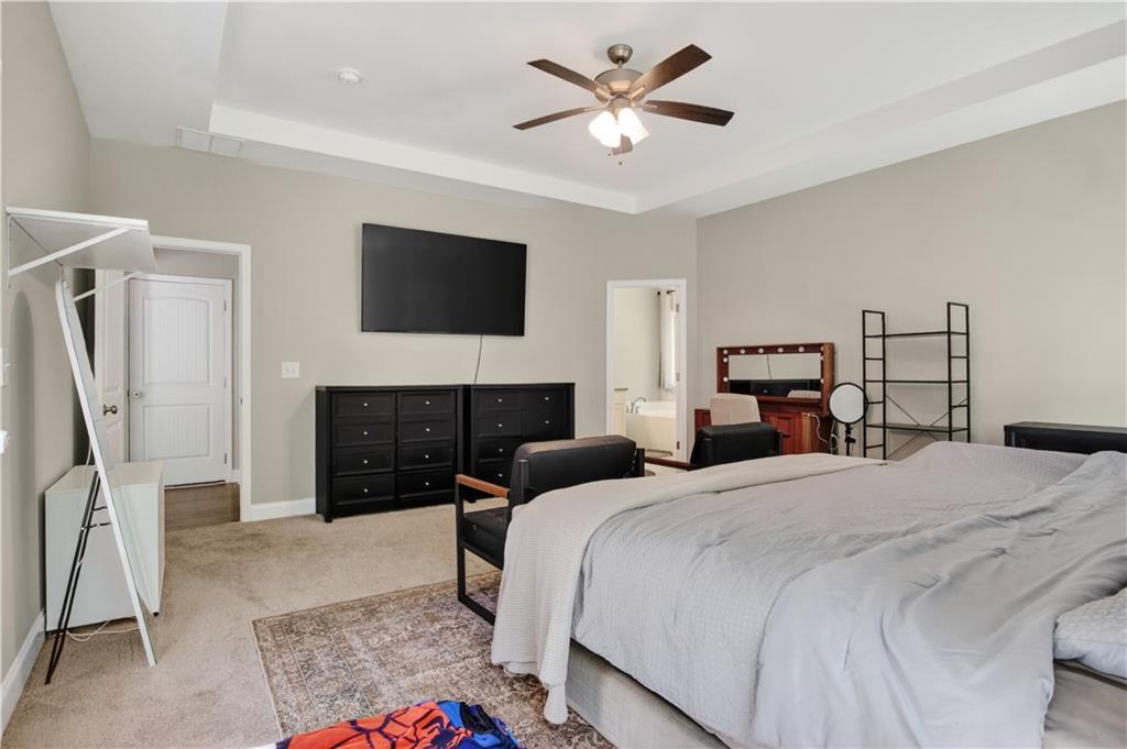 584 Tuxedo Drive Commerce, GA 30530 - Photo 14 of 30 a bedroom with a bed a fireplace and a television