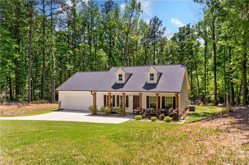 584 Tuxedo Drive Commerce, GA 30530 - Photo 21 of 30 a front view of a house with a garden and porch