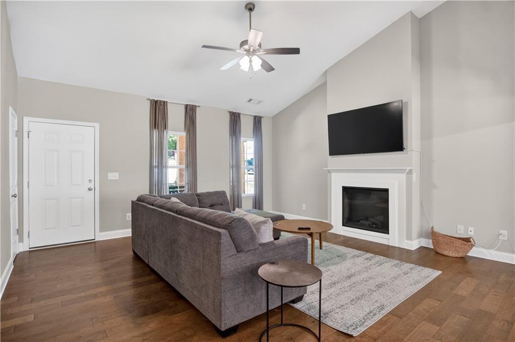 584 Tuxedo Drive Commerce, GA 30530 - Photo 4 of 30 a living room with furniture a fireplace and a flat screen tv