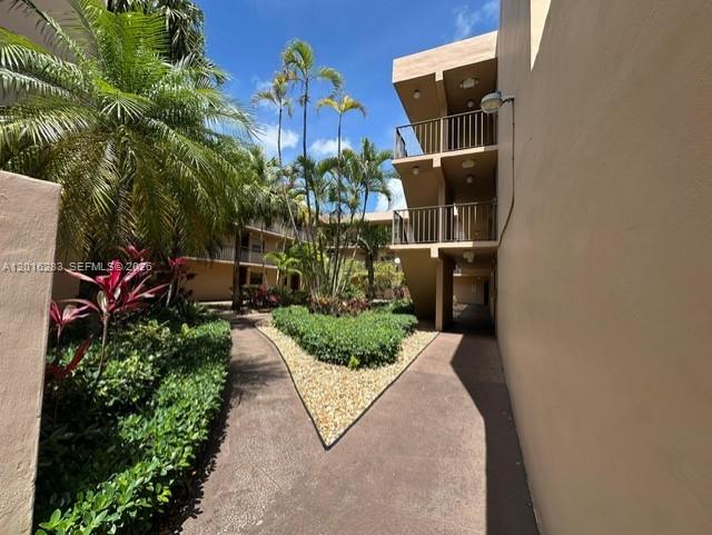 10975 Southwest 107th Street, Unit 110 Miami, FL 33176 - Photo 1 of 26 a backyard of a house with lots of green space and glass windows