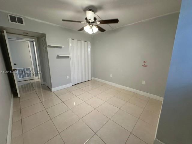 10975 Southwest 107th Street, Unit 110 Miami, FL 33176 - Photo 14 of 26 a view of an empty room with a fan