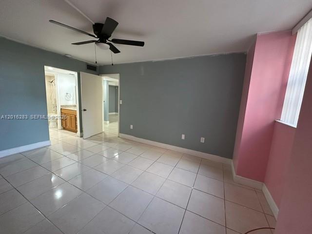10975 Southwest 107th Street, Unit 110 Miami, FL 33176 - Photo 15 of 26 a view of a livingroom with a chandelier fan and kitchen in the background