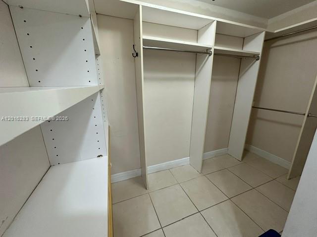 10975 Southwest 107th Street, Unit 110 Miami, FL 33176 - Photo 16 of 26 a view of walk in closet with wooden floors