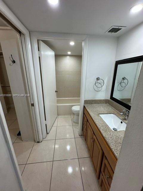 10975 Southwest 107th Street, Unit 110 Miami, FL 33176 - Photo 18 of 26 a bathroom with a granite countertop sink a toilet and a mirror