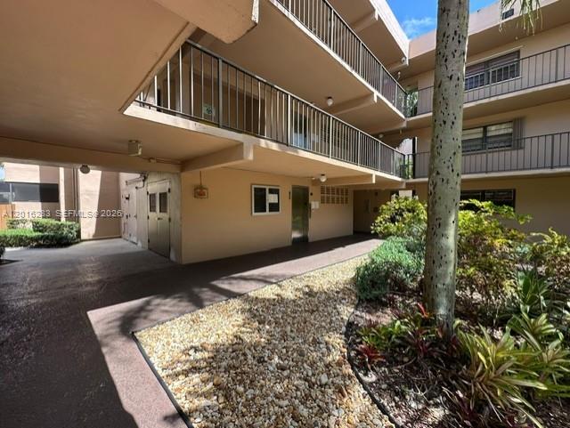 10975 Southwest 107th Street, Unit 110 Miami, FL 33176 - Photo 2 of 26 front view of a house with a yard