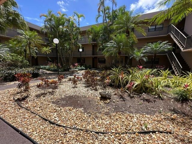 10975 Southwest 107th Street, Unit 110 Miami, FL 33176 - Photo 24 of 26 a backyard of a house with lots of green space