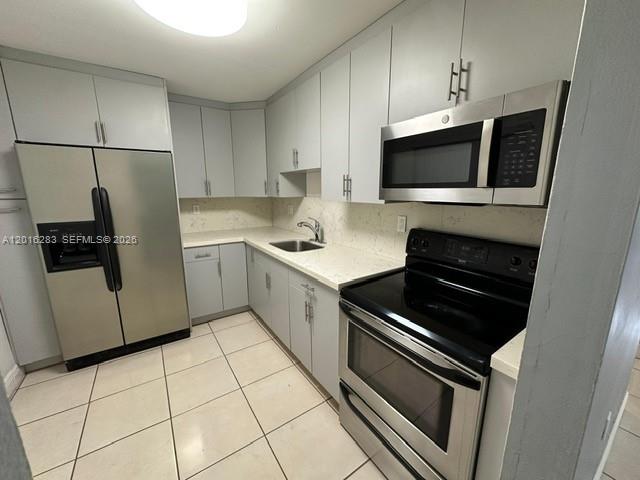 10975 Southwest 107th Street, Unit 110 Miami, FL 33176 - Photo 7 of 26 a kitchen with a sink and steel appliances