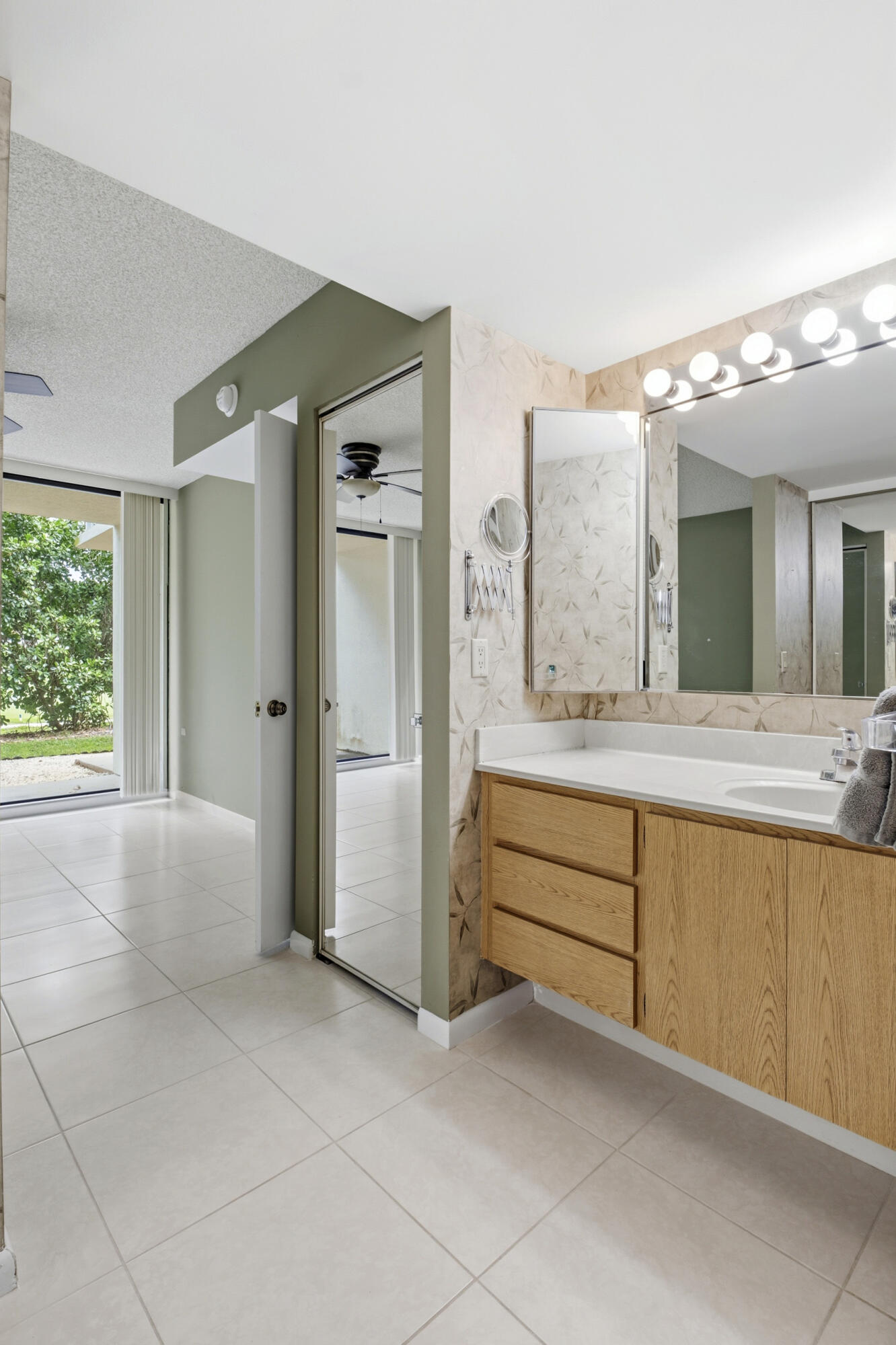 6145 Balboa Circle, Unit 103 Boca Raton, FL 33433 - Photo 16 of 31 a spacious bathroom with a granite countertop sink mirror and a bathtub