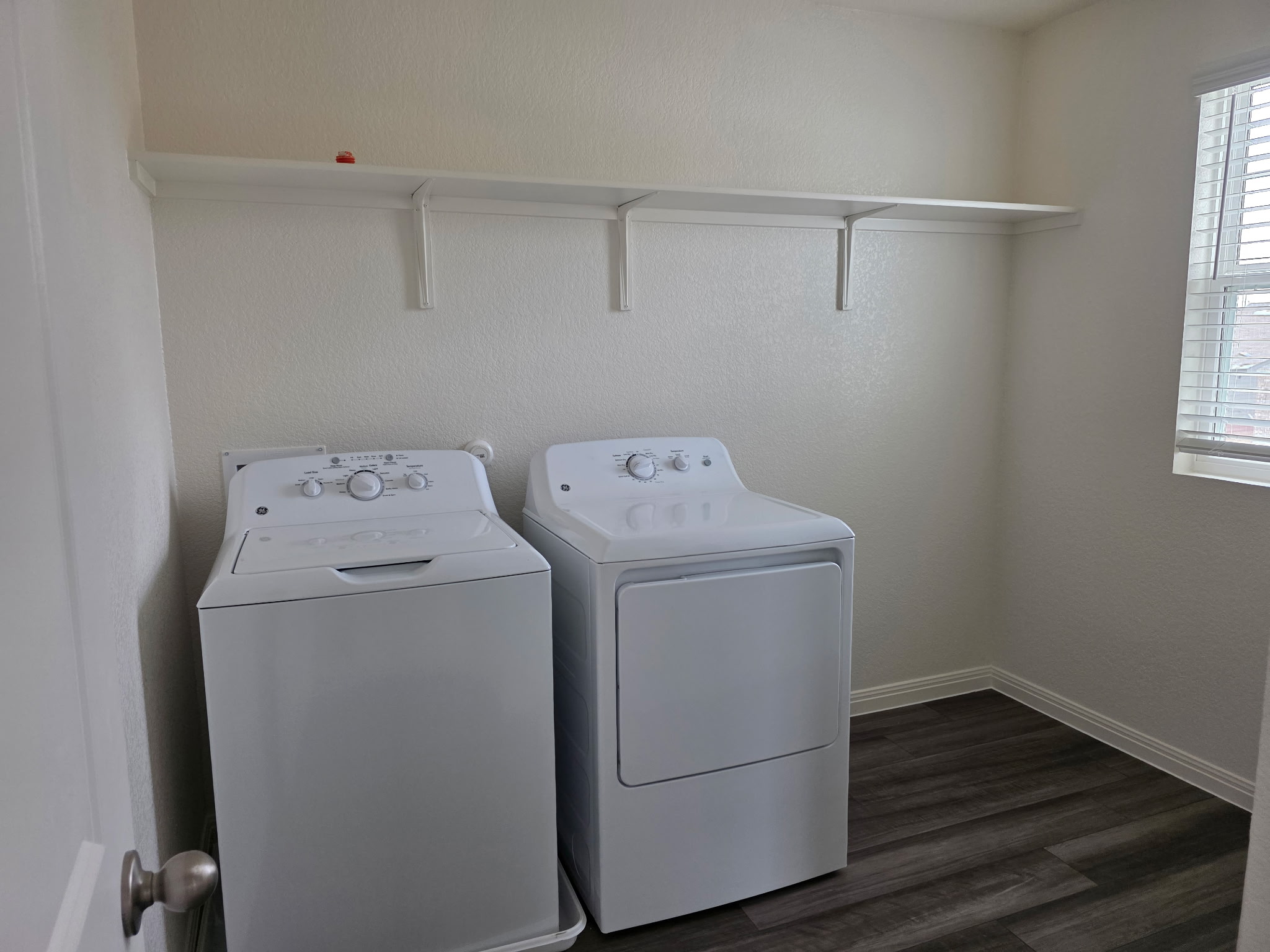 353 Enforcer Loop Jarrell, TX 76537 - Photo 17 of 21 Laundry area with washing machine and dryer, dark wood finished floors, and baseboards