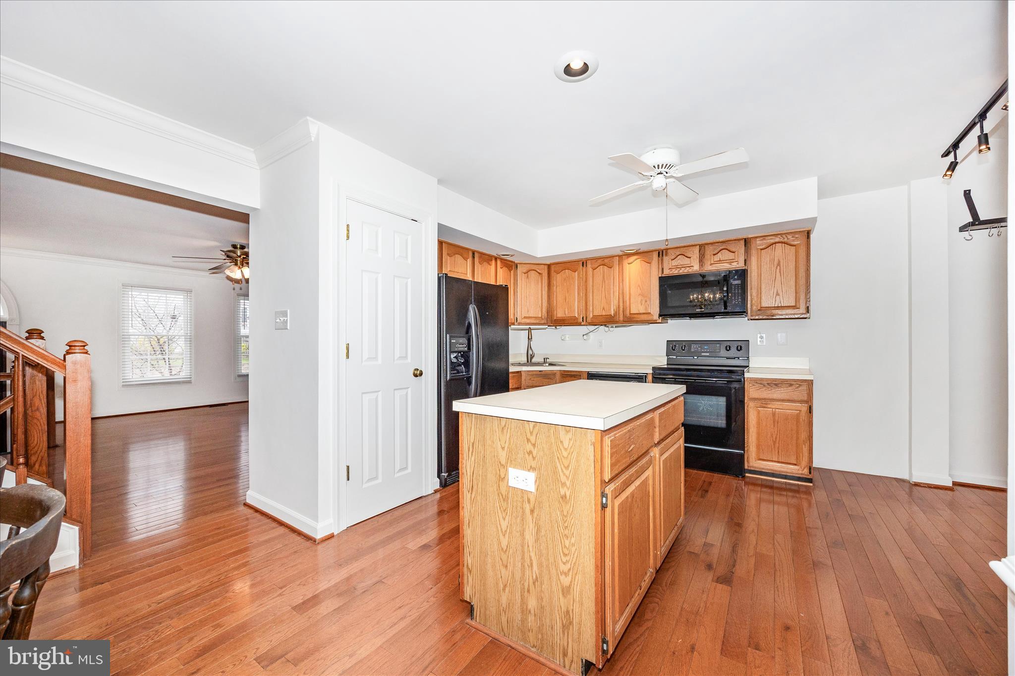 5577 Rivendell Place Frederick, MD 21703 - Photo 12 of 51 a kitchen with a stove top oven a refrigerator a sink and dishwasher with wooden floor