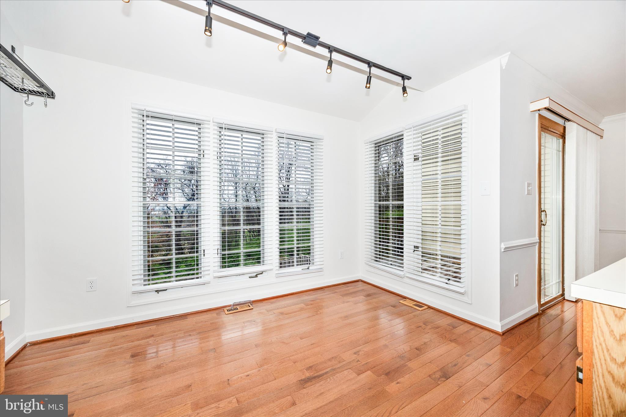 5577 Rivendell Place Frederick, MD 21703 - Photo 15 of 51 a view of an empty room with a window and wooden floor