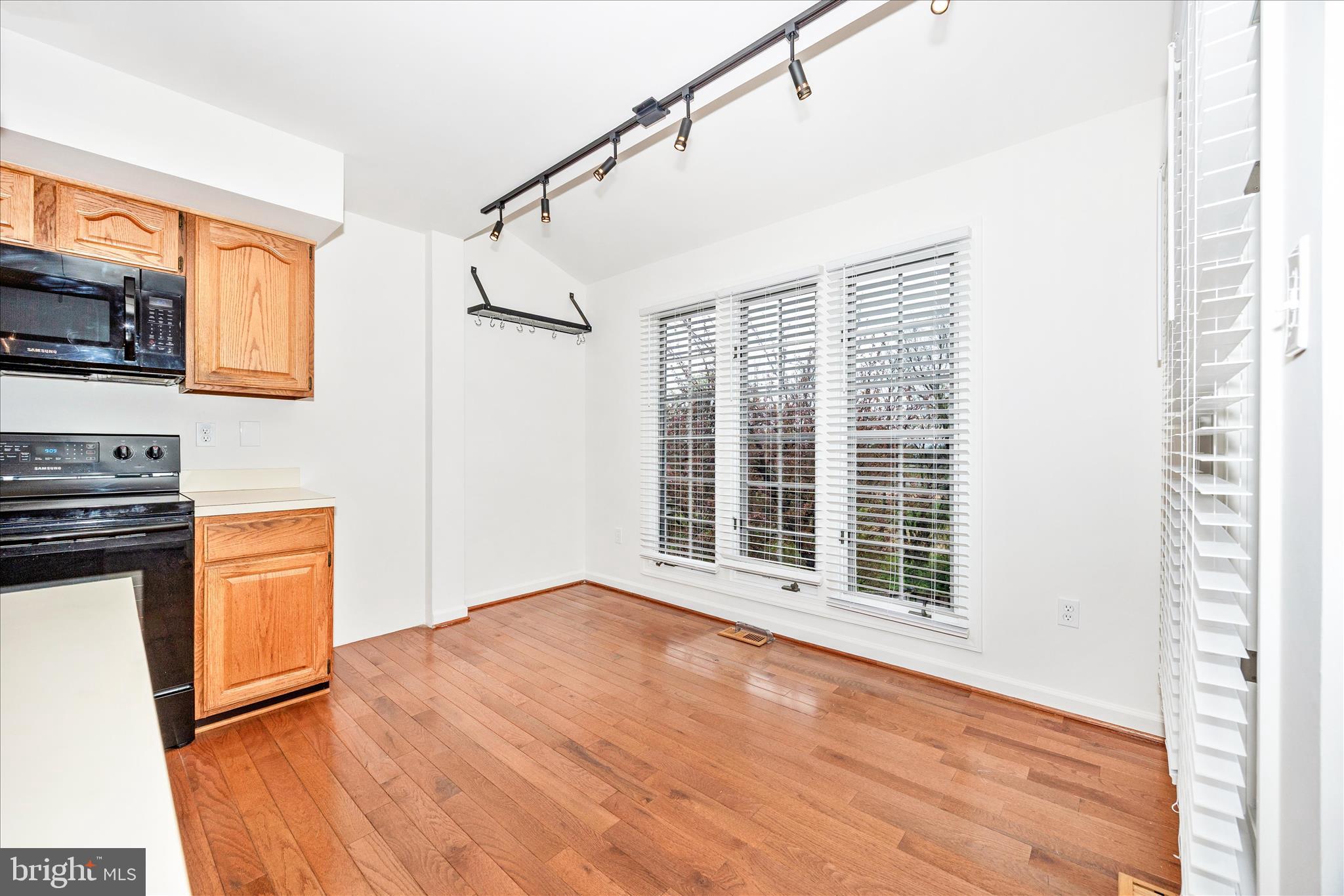 5577 Rivendell Place Frederick, MD 21703 - Photo 16 of 51 a view of an empty room with a window and wooden floor