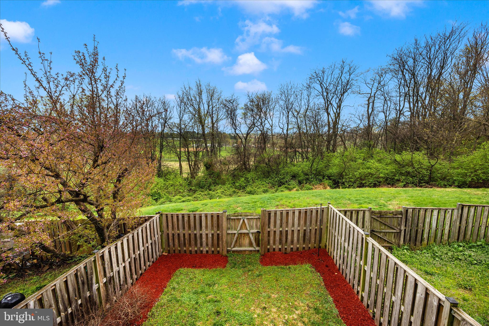 5577 Rivendell Place Frederick, MD 21703 - Photo 45 of 51 a view of a wooden deck with a garden