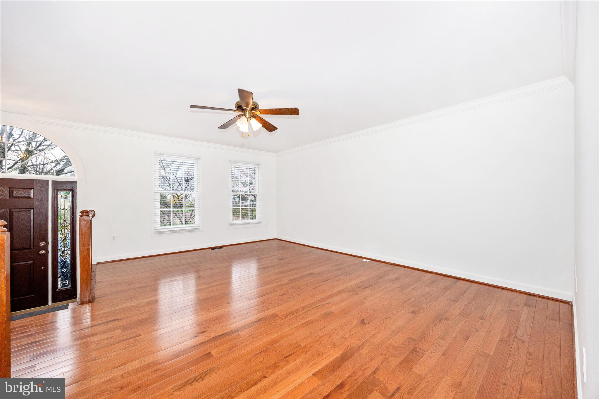 5577 Rivendell Place Frederick, MD 21703 - Photo 6 of 51 a view of an empty room with wooden floor and a window