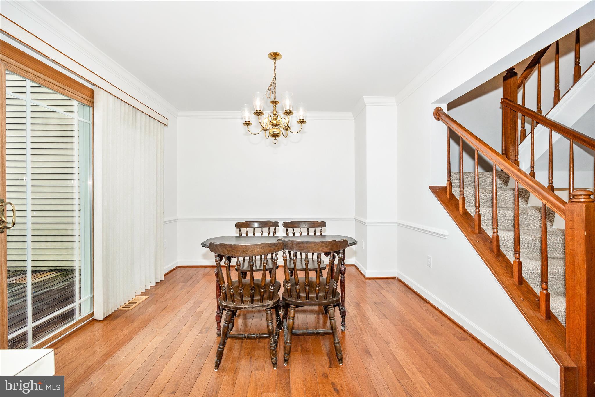 5577 Rivendell Place Frederick, MD 21703 - Photo 10 of 51 a view of a dining room with furniture wooden floor and staircase