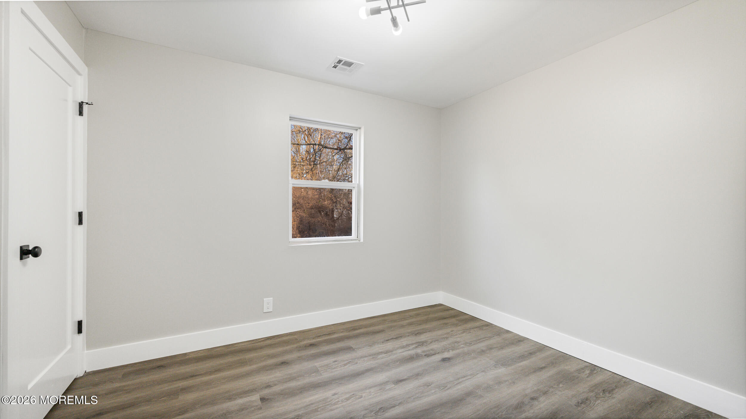 4 Story Street New Egypt, NJ 08533 - Photo 11 of 16 a view of an empty room with wooden floor and a window
