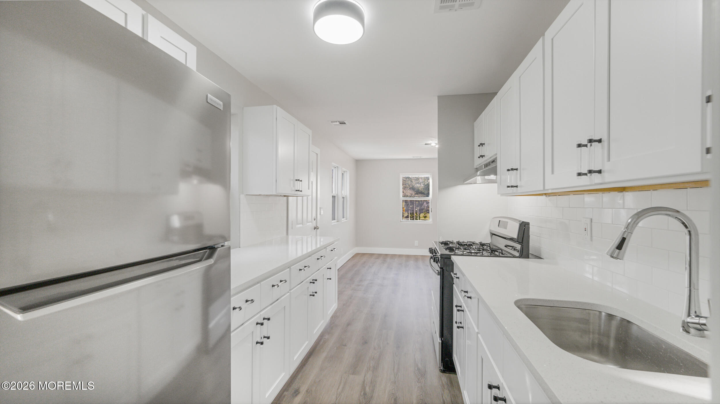 4 Story Street New Egypt, NJ 08533 - Photo 6 of 16 a kitchen with granite countertop a sink a refrigerator and cabinets