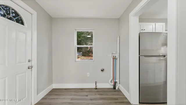 a view of a hallway with wooden floor and closet area