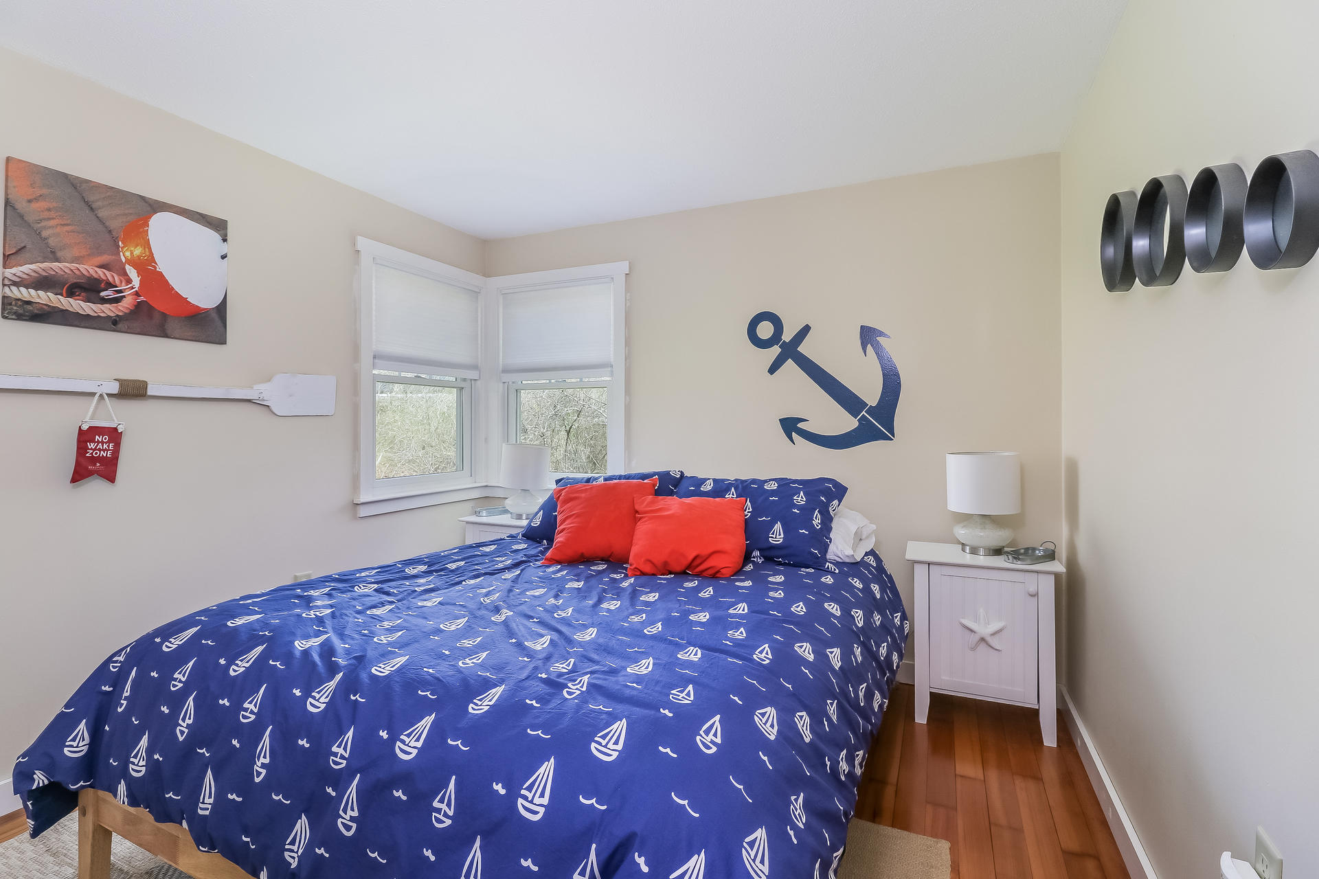 50 Oak Ridge Road Eastham, MA 02642 - Photo 14 of 20 a bedroom with a bed and painting on the wall