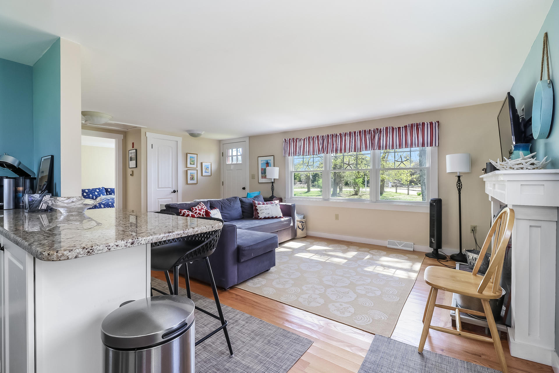 50 Oak Ridge Road Eastham, MA 02642 - Photo 4 of 20 a living room with furniture a flat screen tv and a large window