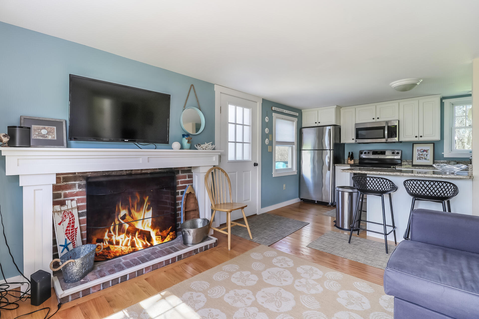 50 Oak Ridge Road Eastham, MA 02642 - Photo 5 of 20 a living room with furniture a flat screen tv and a fireplace