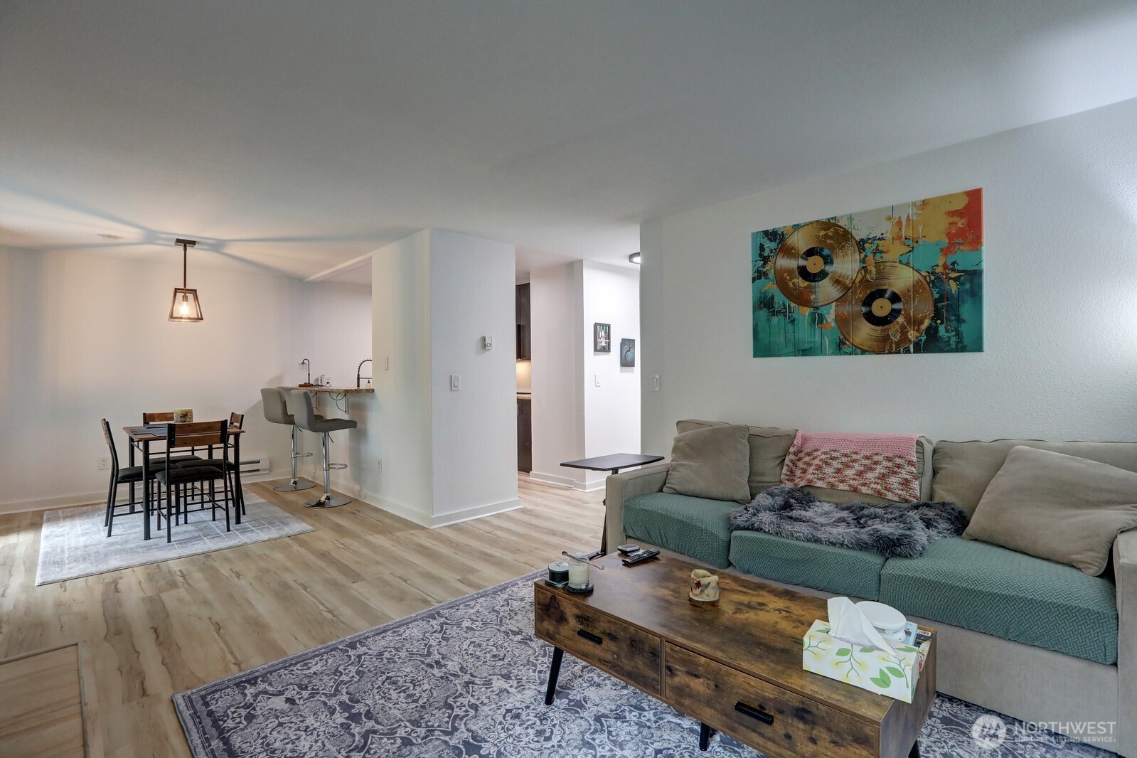 9806 28th Avenue Southwest, Unit A201 Seattle, WA 98126 - Photo 5 of 14 a living room with furniture and wooden floor
