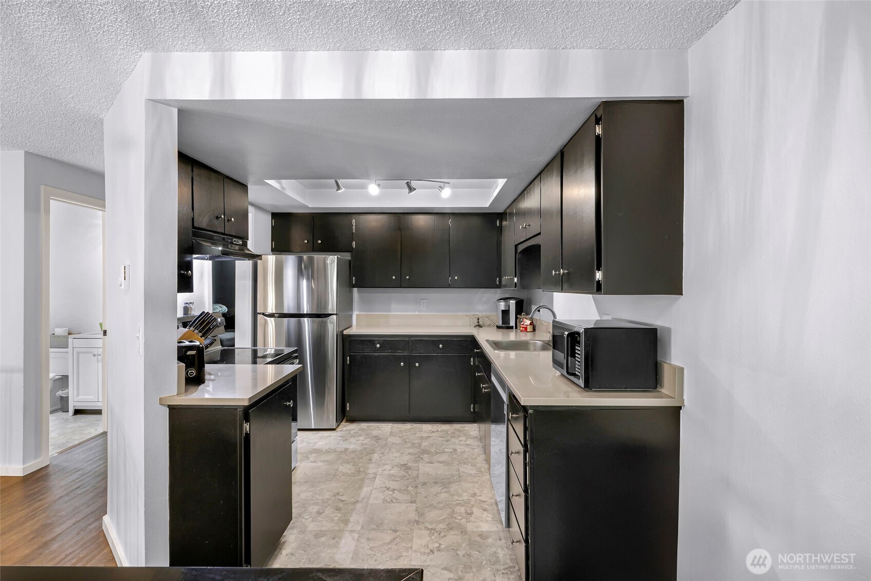 1211 North 8th Street, Unit 2 Mount Vernon, WA 98273 - Photo 11 of 38 a kitchen with counter top space cabinets and stainless steel appliances