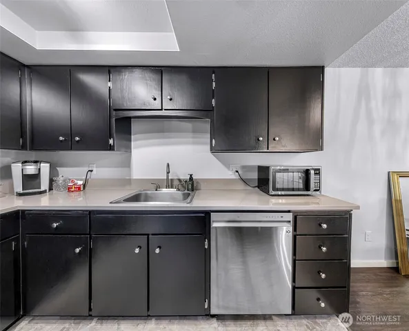 a kitchen with a sink and cabinets