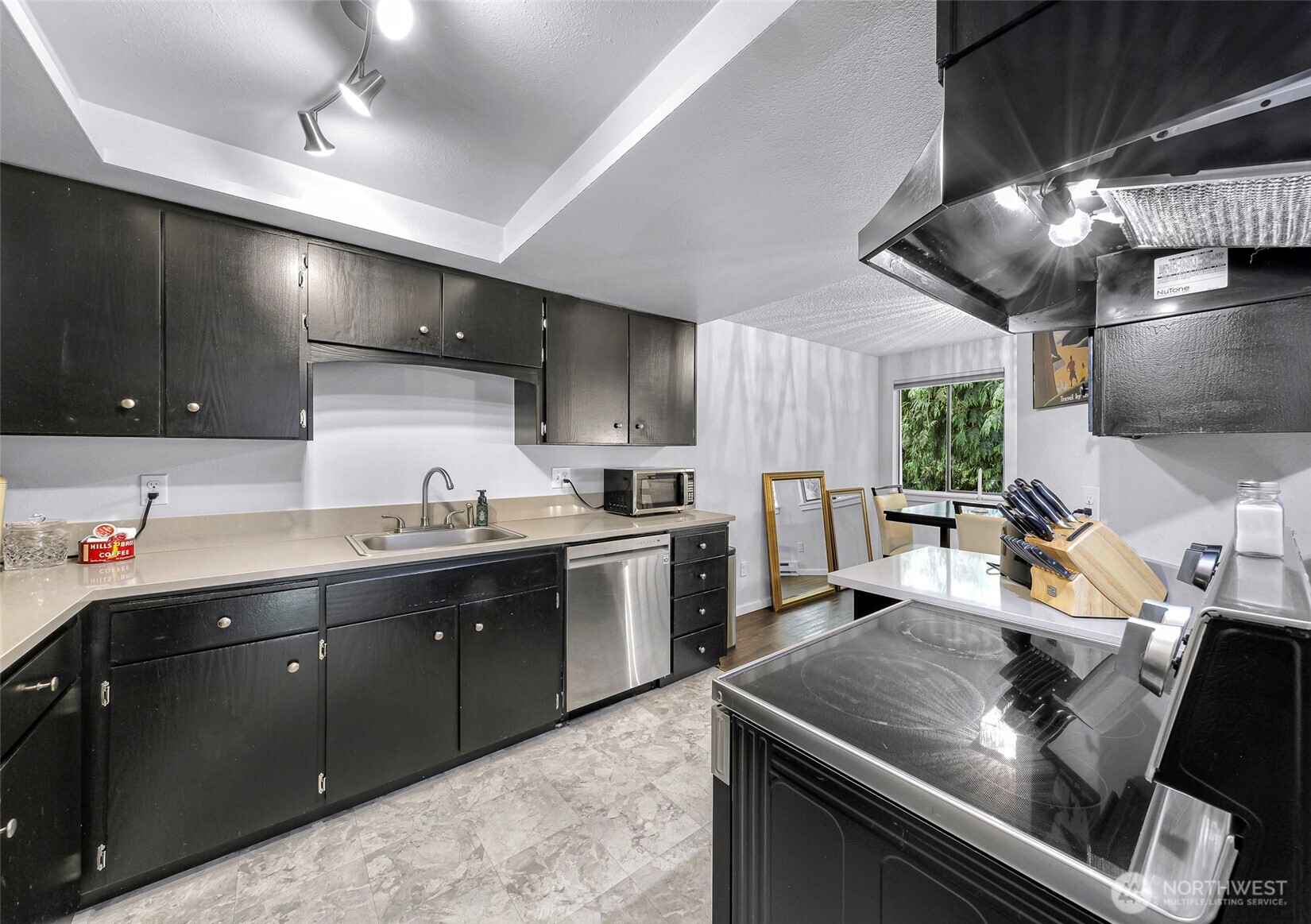 1211 North 8th Street, Unit 2 Mount Vernon, WA 98273 - Photo 16 of 38 a kitchen with stainless steel appliances kitchen island granite countertop a sink counter space cabinets and stainless steel appliances
