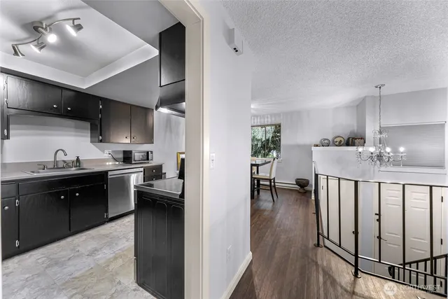 a kitchen with stainless steel appliances granite countertop a sink dishwasher stove and oven