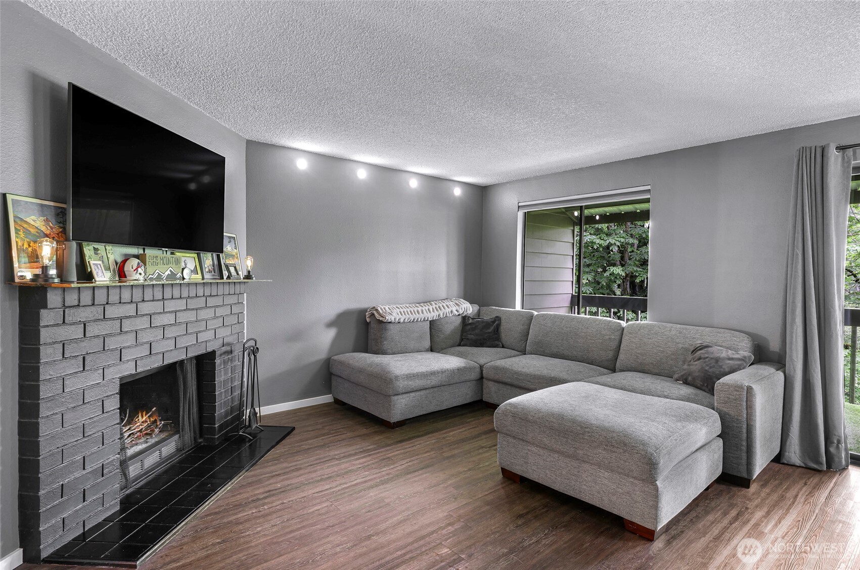 1211 North 8th Street, Unit 2 Mount Vernon, WA 98273 - Photo 19 of 38 a living room with furniture a flat screen tv and a fireplace