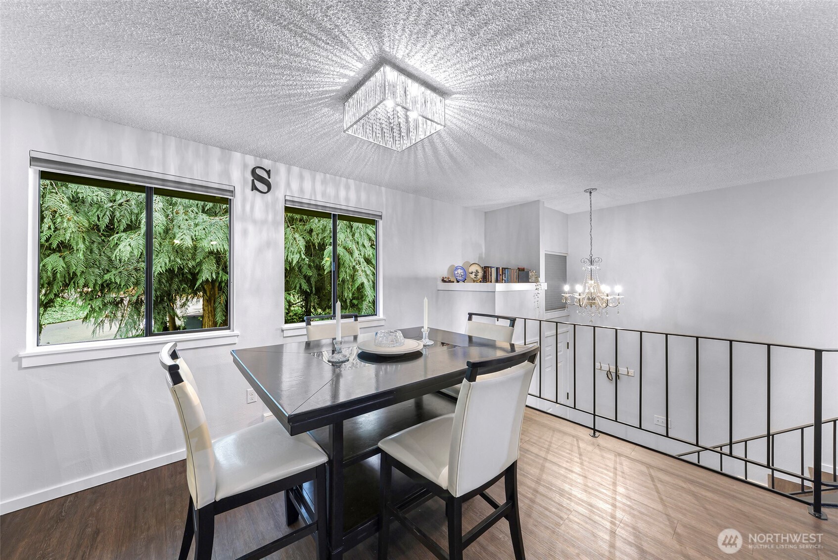 1211 North 8th Street, Unit 2 Mount Vernon, WA 98273 - Photo 9 of 38 a dining room with wooden floor a chandelier a wooden table and chairs
