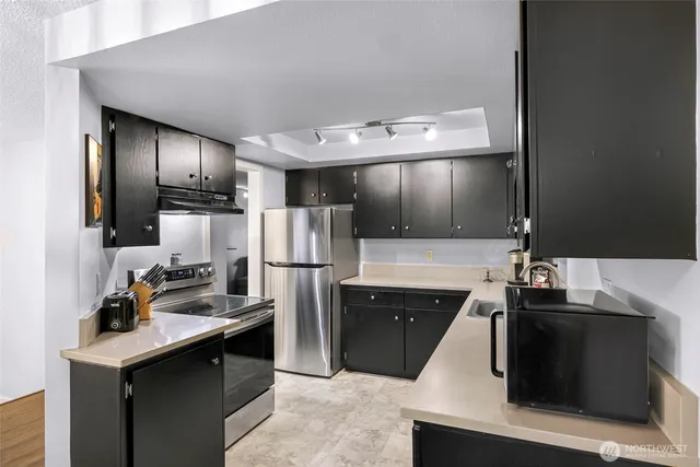 a kitchen with refrigerator and sink