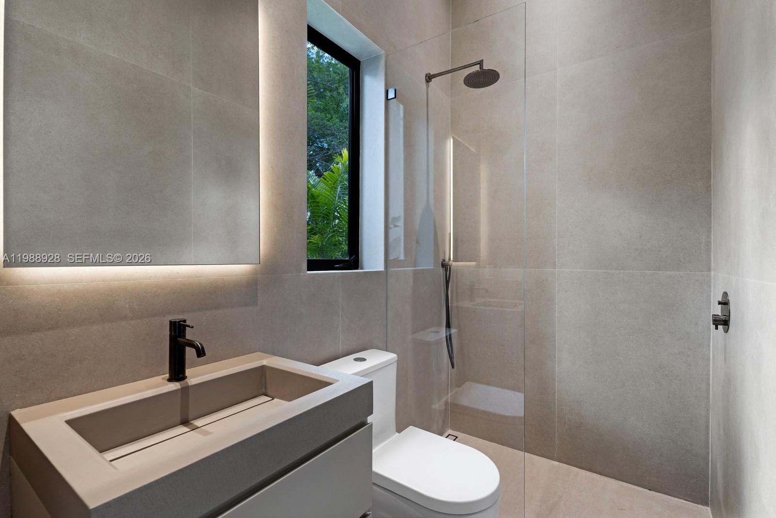 5545 Southwest 81st Terrace Miami, FL 33143 - Photo 52 of 100 a bathroom with a sink a toilet a window and shower