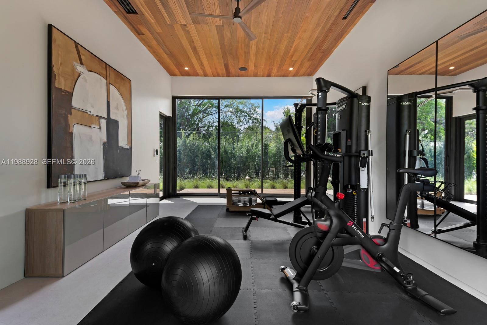 5545 Southwest 81st Terrace Miami, FL 33143 - Photo 63 of 100 a room with gym equipment and floor to ceiling window